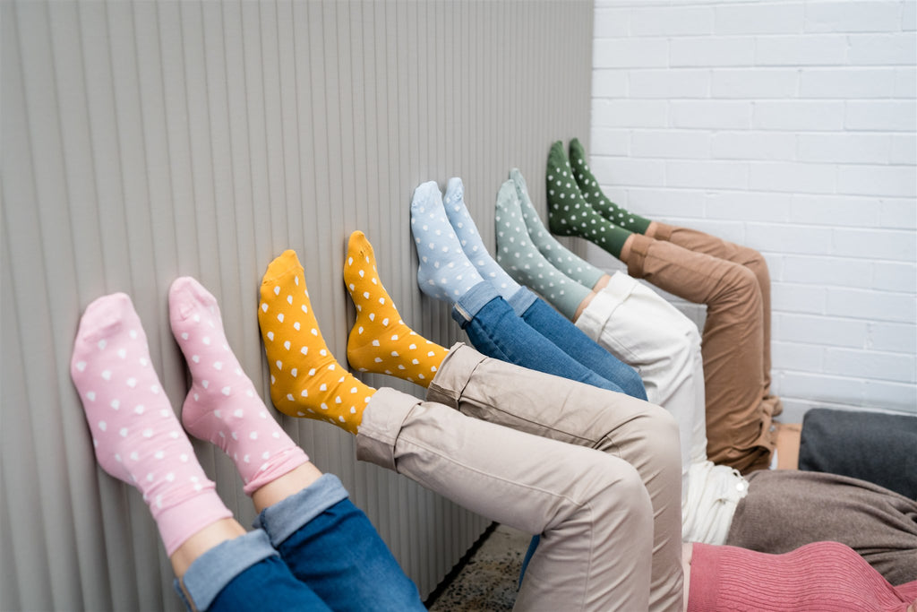 Pastel socks lined up on a wall